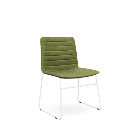 The Sled Base Chair in white with a green seat