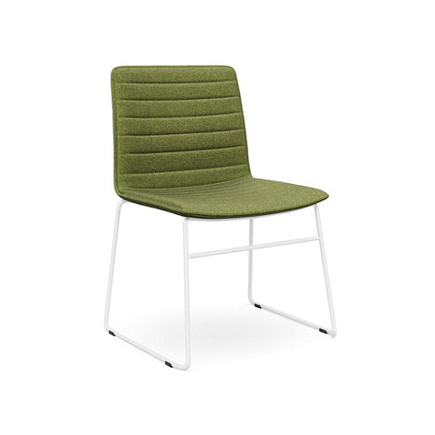 The Sled Base Chair in white with a green seat