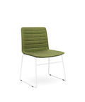 The Sled Base Chair in white with a green seat