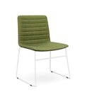 The Sled Base Chair in white with a green seat